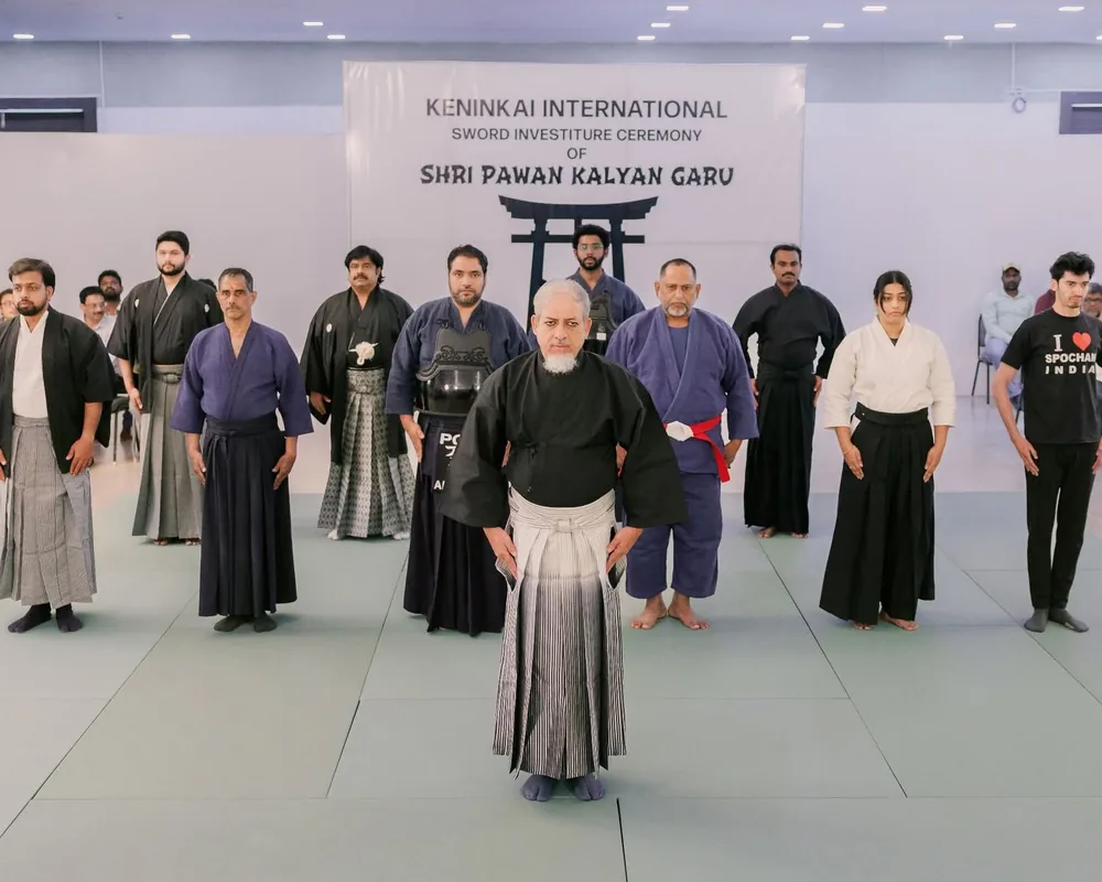 Golden Dragons members in Kendo armour, hakama, judo gi and SpoChan shirts standing in formal rei on the mats